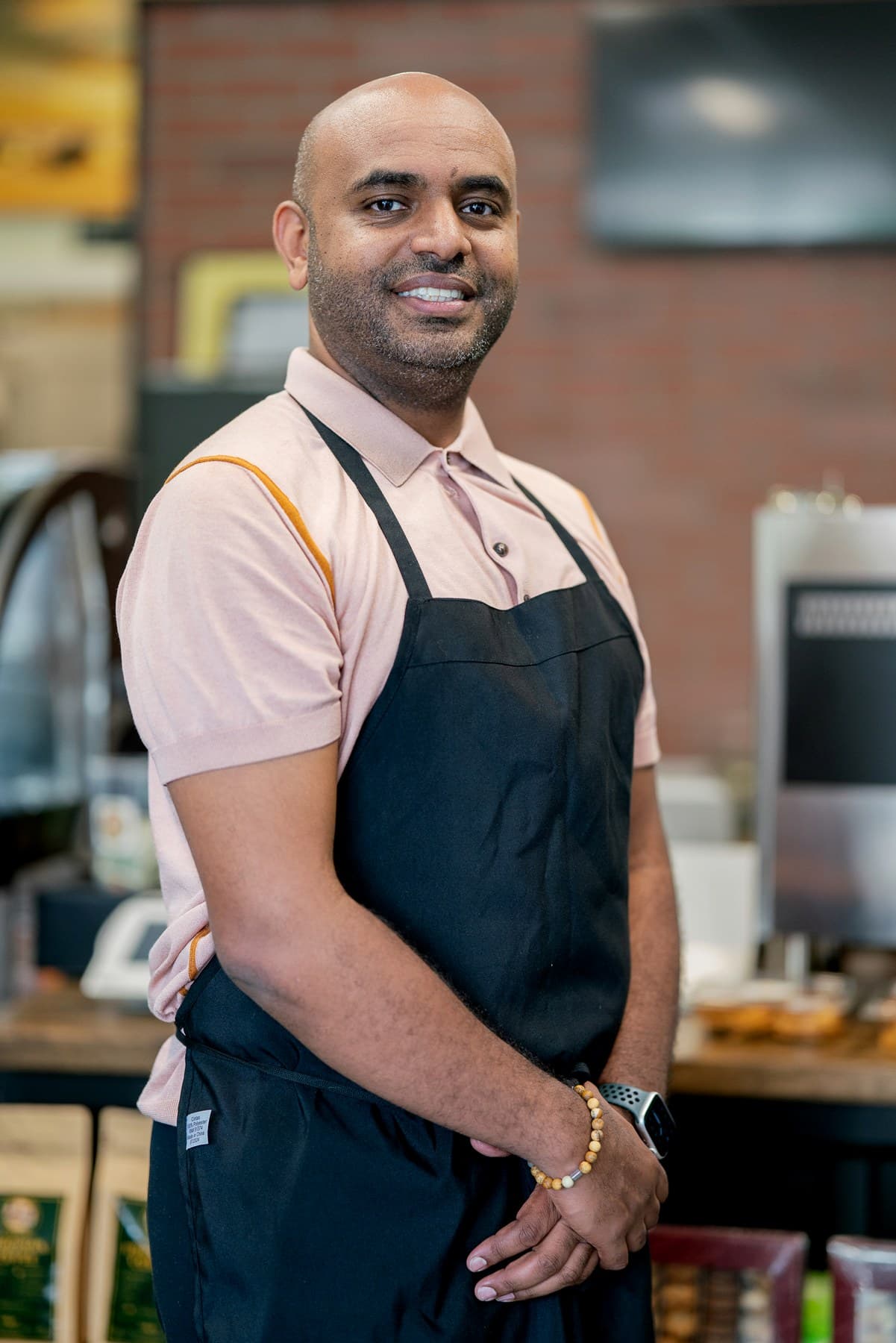 Buna House team member wearing an apron inside the cafe